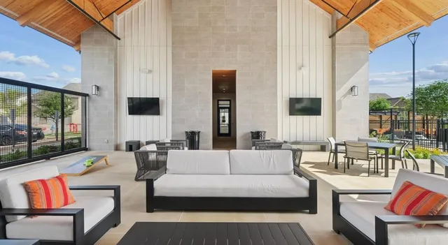 a view of a patio with a table and chairs under an umbrella