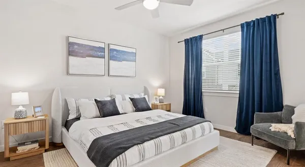 a bedroom with bed and a chandelier