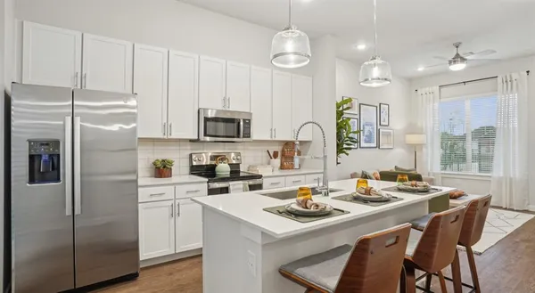 a kitchen with a refrigerator a stove a sink and a refrigerator