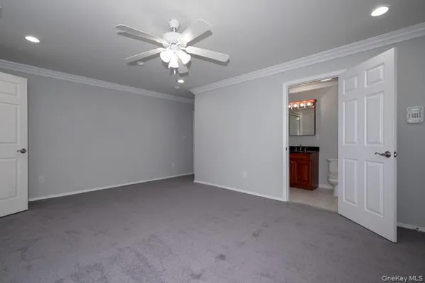 an empty room with chandelier fan