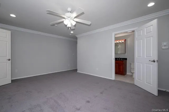 an empty room with chandelier fan