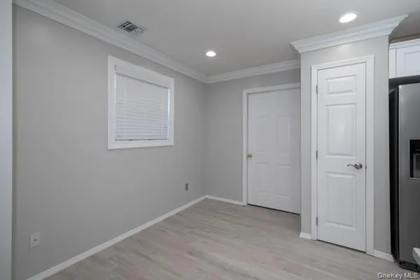 an empty room with windows and closet