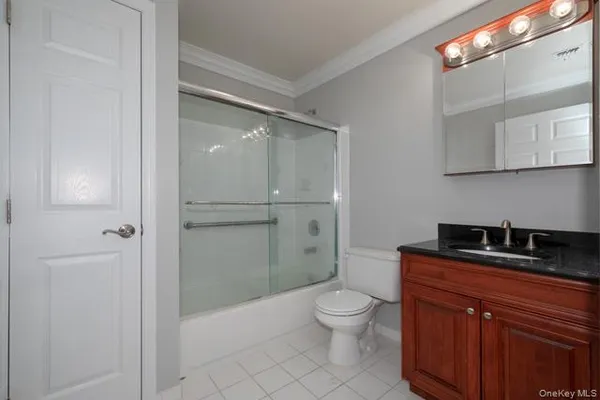 a white toilet sitting next to a bathroom sink