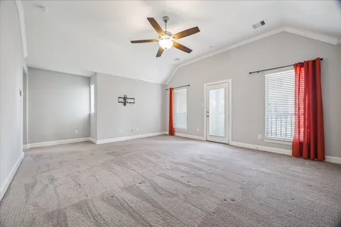 a view of an empty room with a ceiling fan