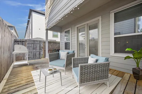 a balcony with furniture and wooden floor