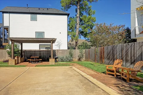 a view of a patio with table and chairs with wooden fence and plants