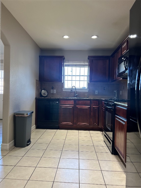 10902 Seneca Street Houston, TX 77016 - Photo 4 of 14 a kitchen with a stove a sink and a refrigerator