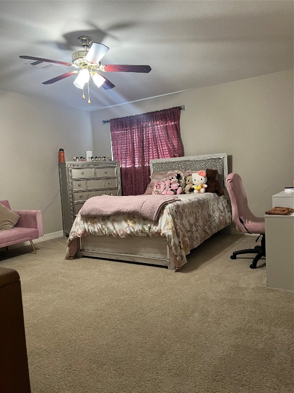 10902 Seneca Street Houston, TX 77016 - Photo 10 of 14 a bedroom with bed and a chandelier