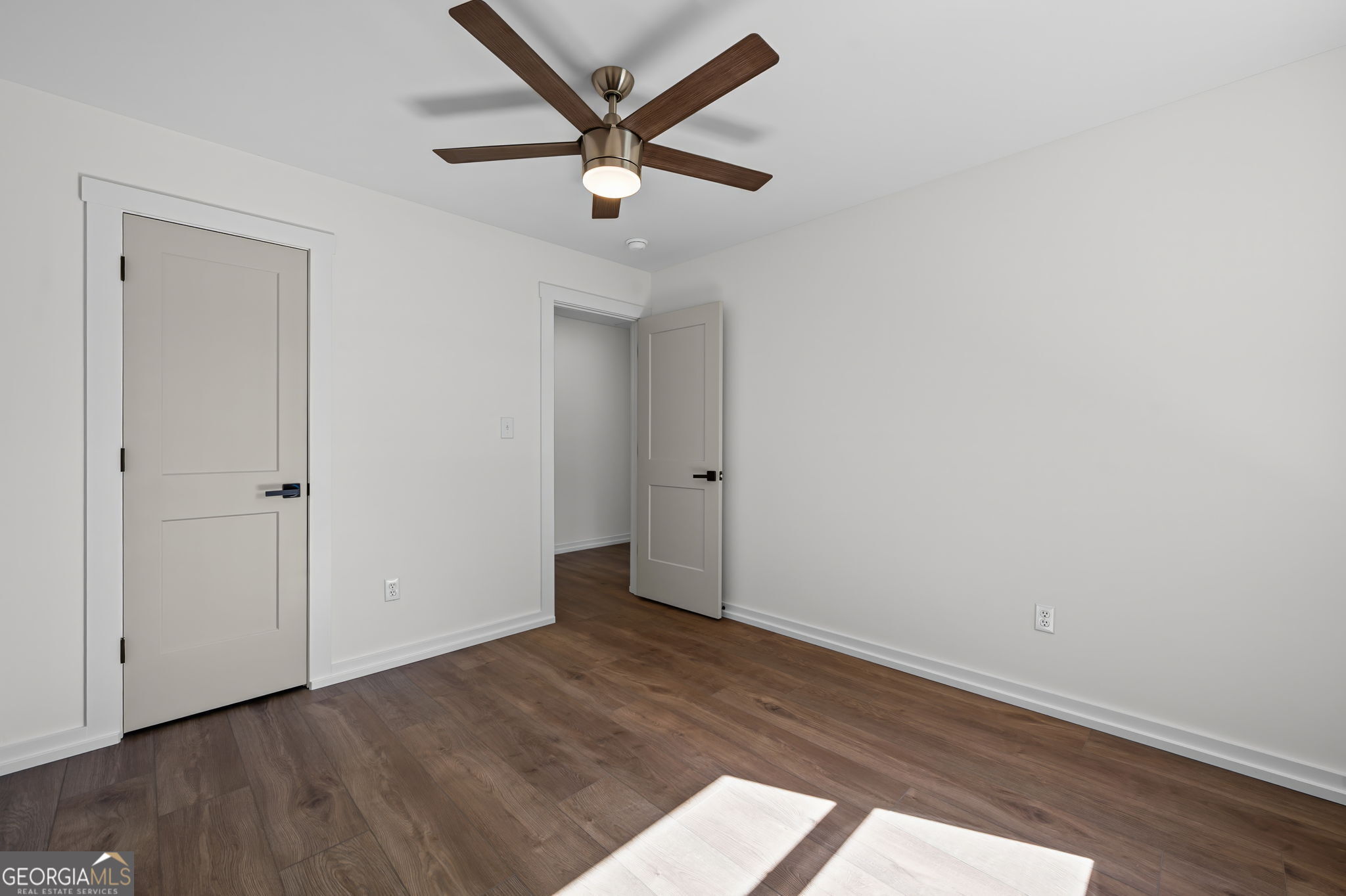 85 Franklin Road Newnan, GA 30263 - Photo 15 of 37 an empty room with wooden floor and a ceiling fan
