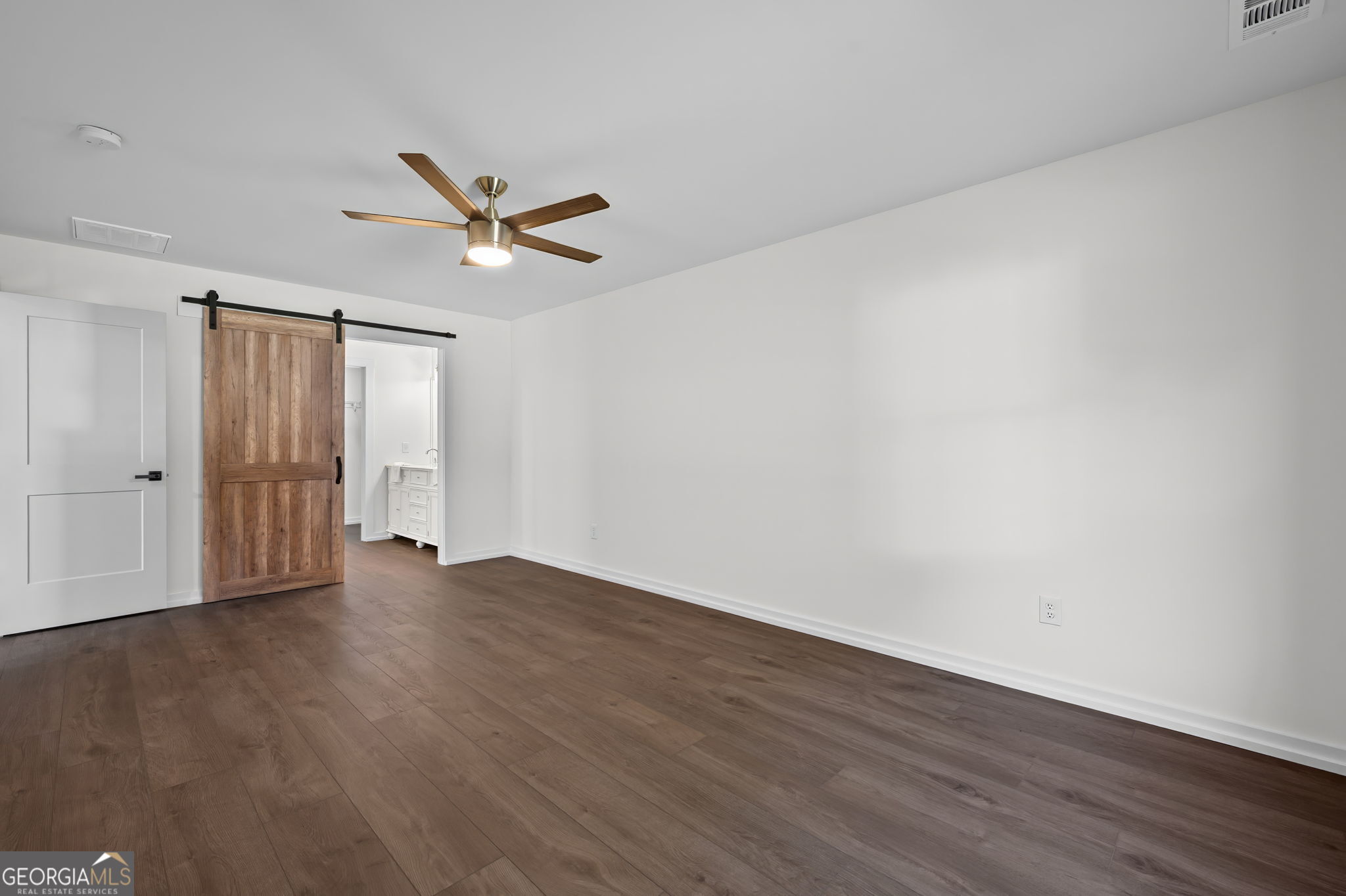 85 Franklin Road Newnan, GA 30263 - Photo 20 of 37 an empty room with wooden floor ceiling fan and windows