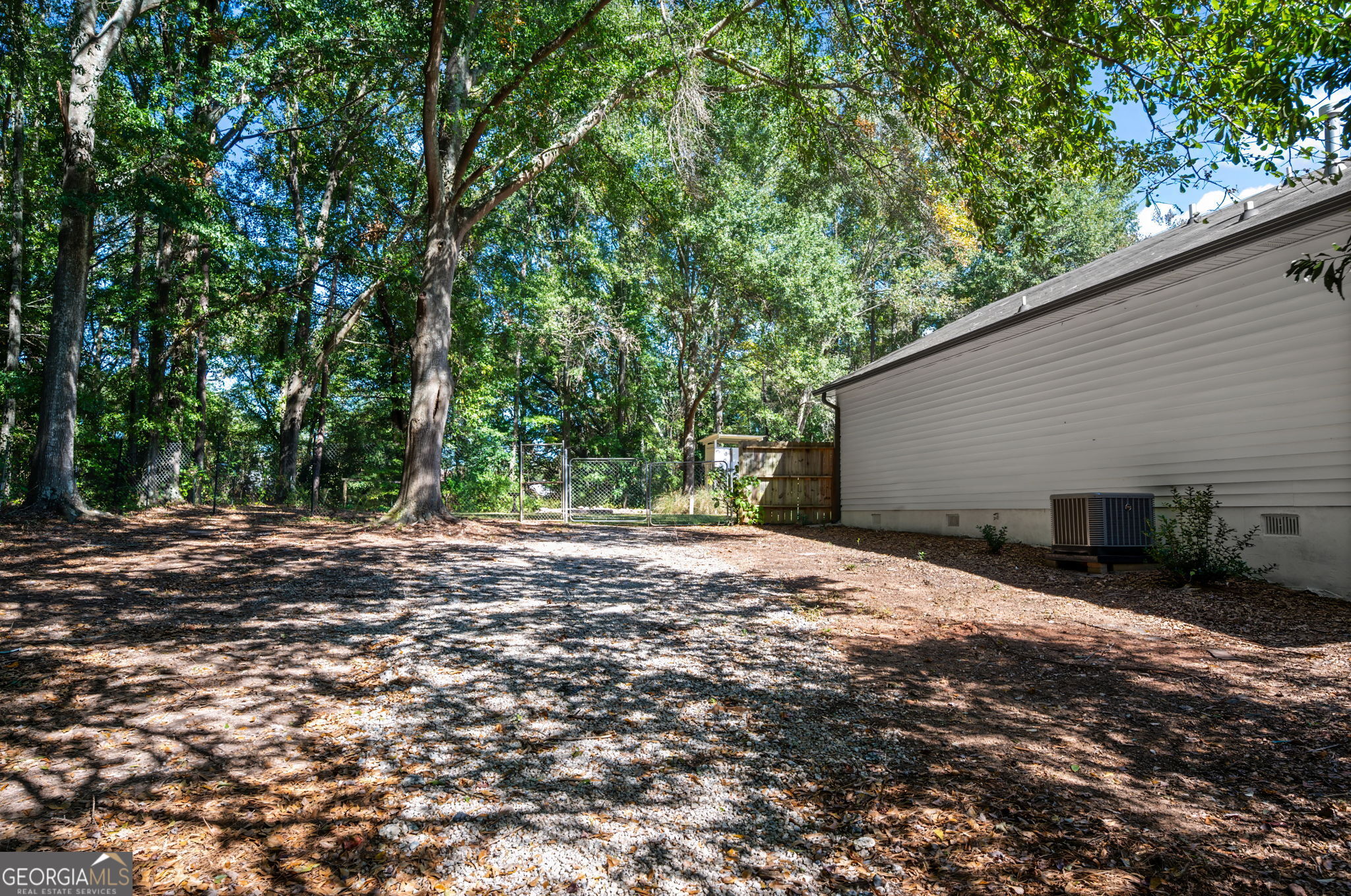 85 Franklin Road Newnan, GA 30263 - Photo 32 of 37 a backyard of a house with large trees and outdoor seating