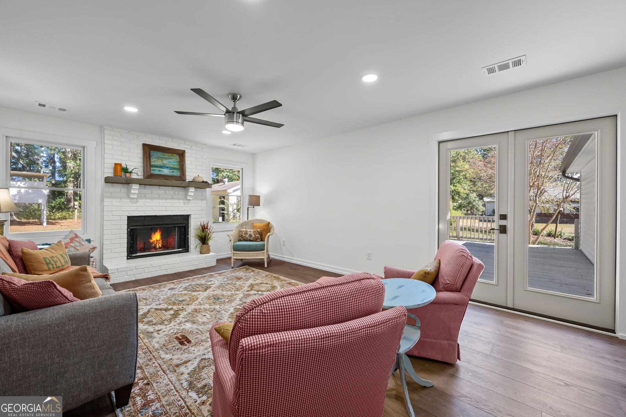85 Franklin Road Newnan, GA 30263 - Photo 4 of 37 a living room with furniture a fireplace and a flat screen tv