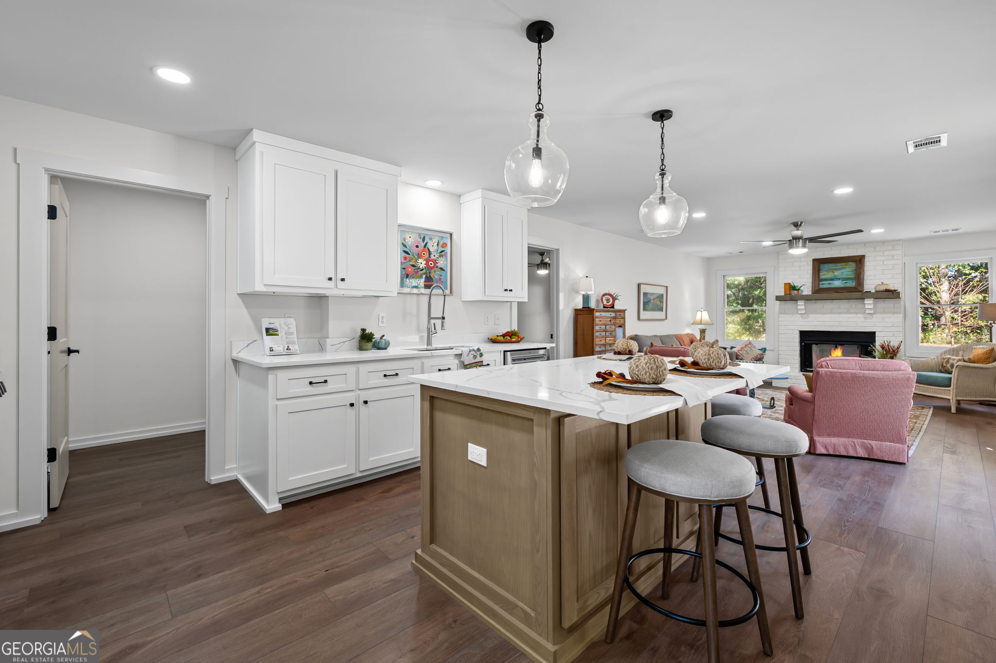 85 Franklin Road Newnan, GA 30263 - Photo 8 of 37 a kitchen that has a lot of cabinets in it with stainless steel appliances granite countertop a stove a sink a refrigerator and white cabinets with wooden floor