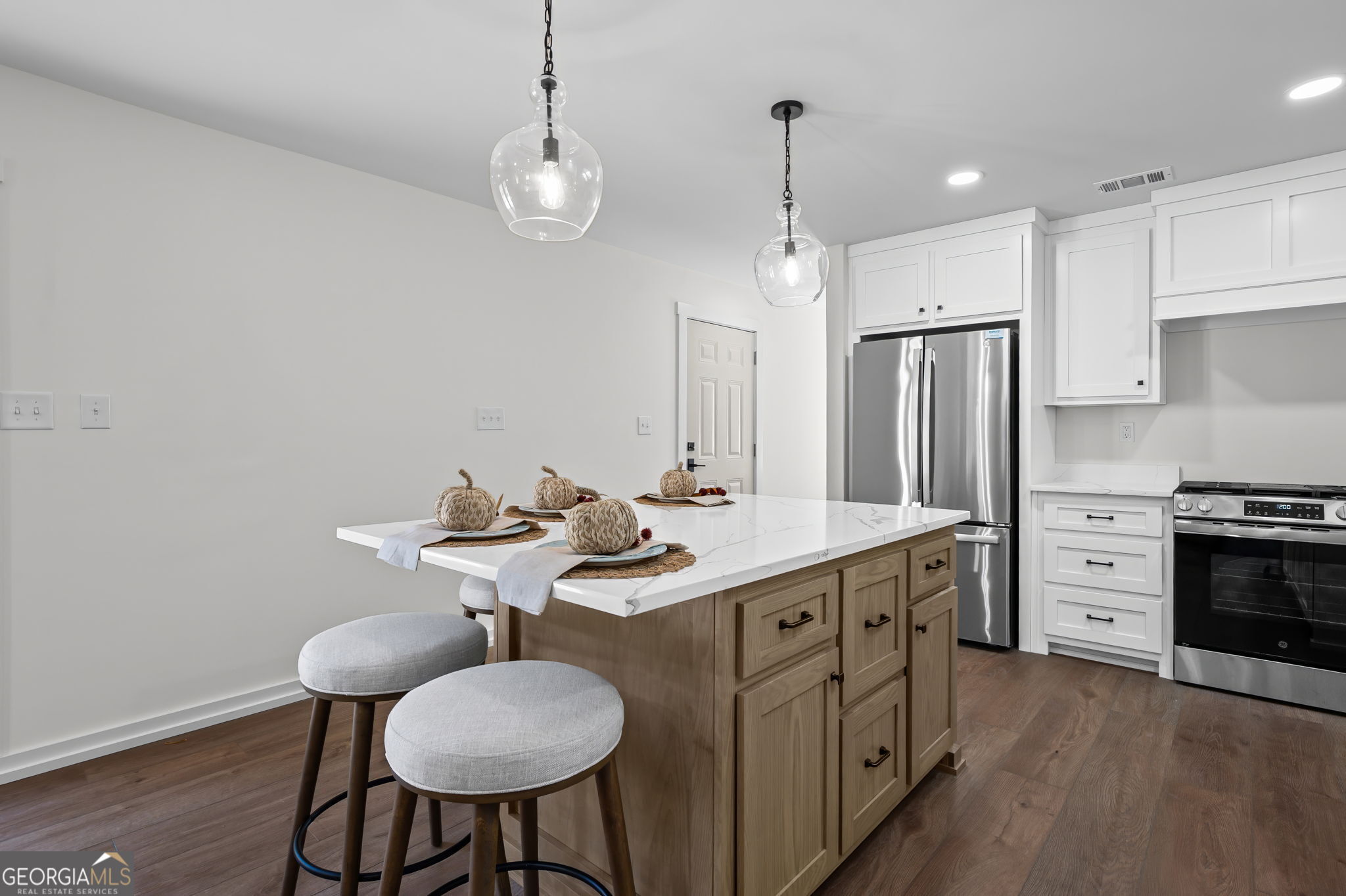 85 Franklin Road Newnan, GA 30263 - Photo 10 of 37 a kitchen with stainless steel appliances a kitchen island hardwood floor and a sink