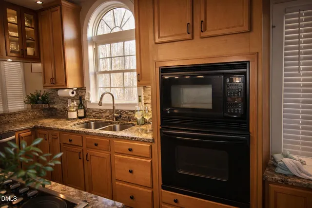 a kitchen with cabinets and stainless steel appliances