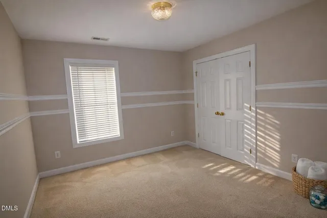 a view of a livingroom with a ceiling fan and window