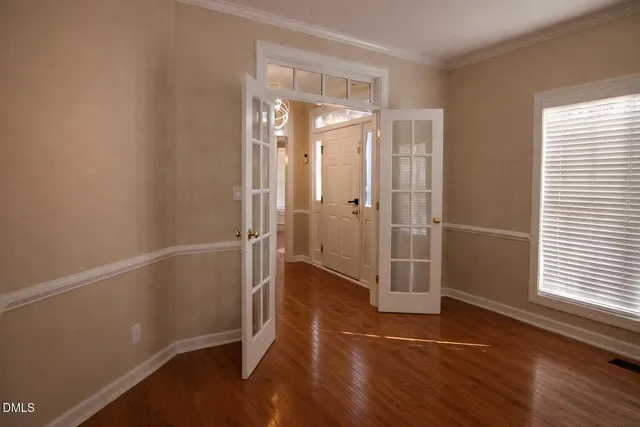 a view of entryway and hall with wooden floor
