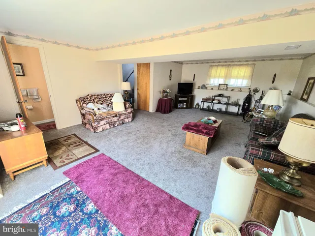a bedroom with furniture and a rug