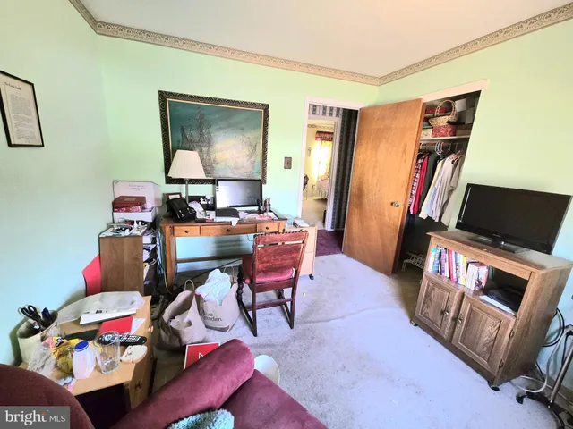 a reading room with furniture and a flat screen tv