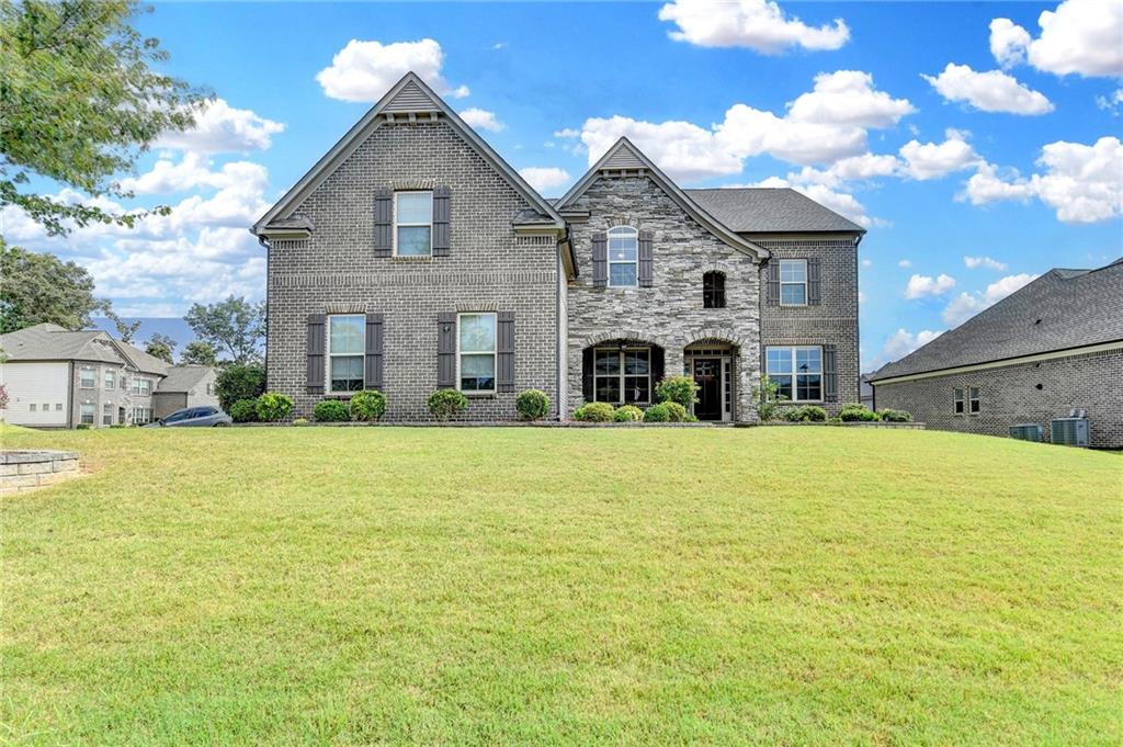 a view of a house with pool and a yard