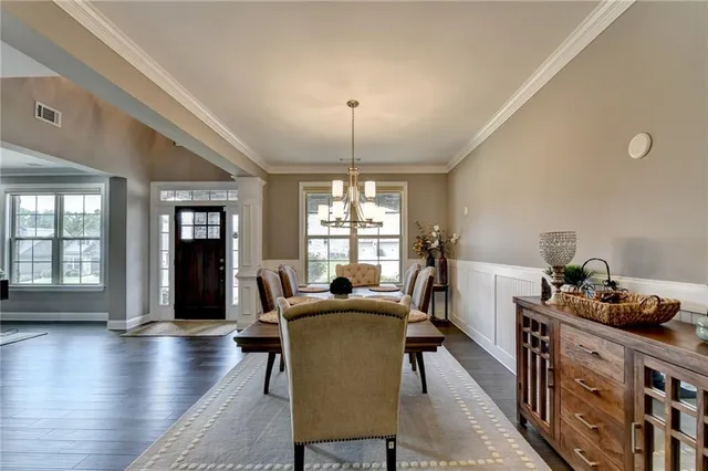 a living room with furniture a fireplace and a large window