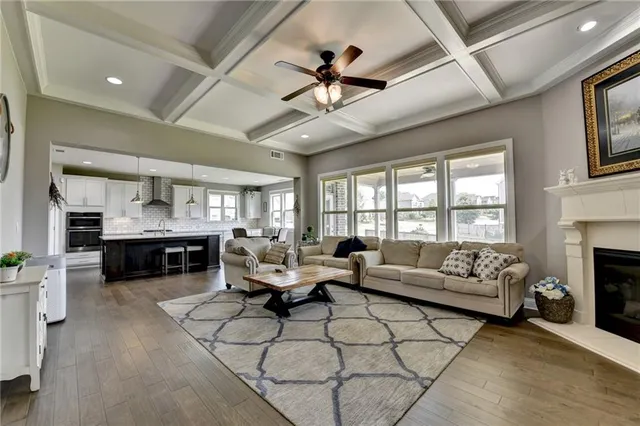 a living room with fireplace furniture and a flat screen tv