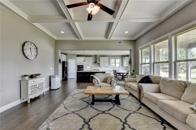 a living room with fireplace furniture and a flat screen tv