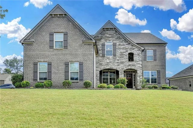 a front view of a house with a yard