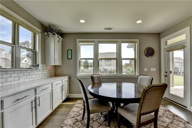 a large kitchen with stainless steel appliances granite countertop a lot of counter space a sink and cabinets