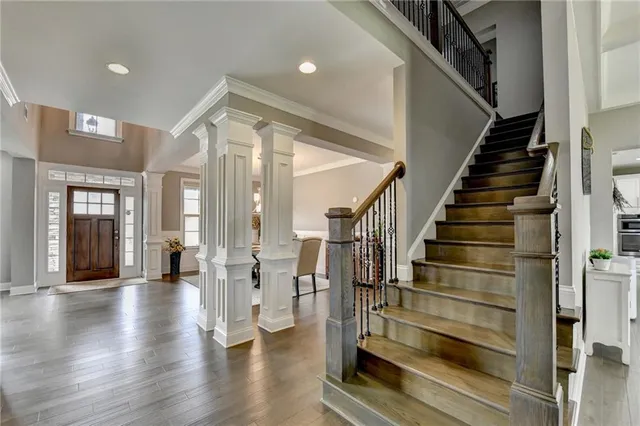 a bedroom with a large bed and a chandelier