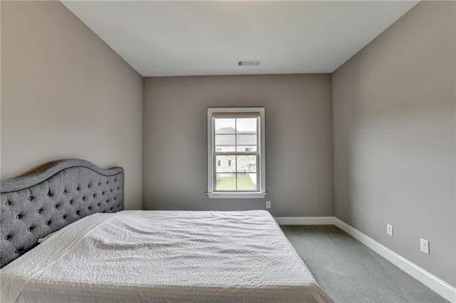 a bathroom with a granite countertop sink a toilet a mirror and shower