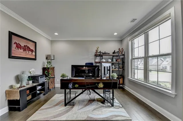 a dining room with furniture a chandelier and wooden floor