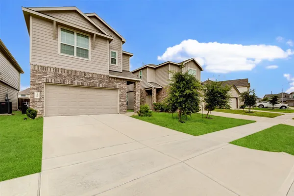 a front view of house with yard and green space
