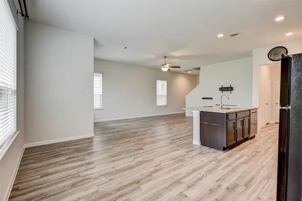 a kitchen with stainless steel appliances granite countertop a stove top oven and wooden floor