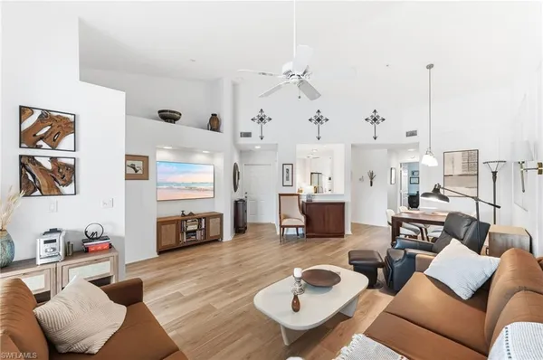 a living room with furniture kitchen view and a fireplace