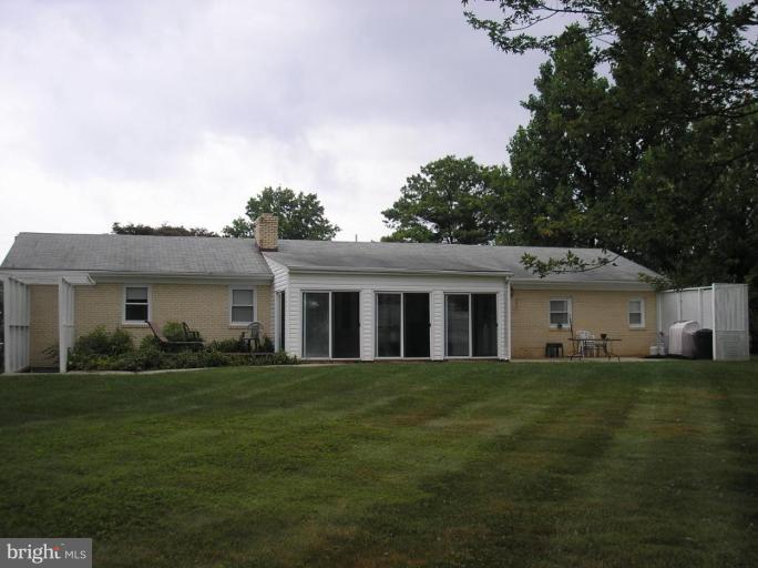 12915 Penn Shop Road Mount Airy, MD 21771 - Photo 2 of 3 a front view of a house with a garden