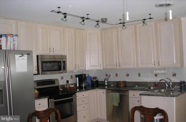 12915 Penn Shop Road Mount Airy, MD 21771 - Photo 3 of 3 a kitchen with stainless steel appliances a stove a sink a refrigerator and cabinets