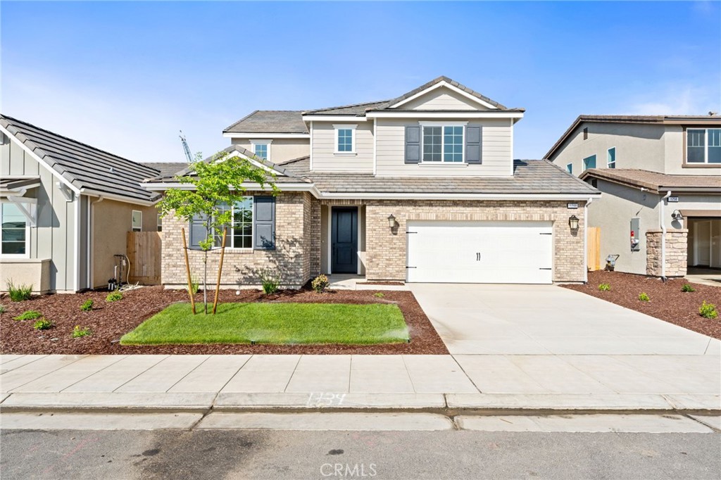 1266 Talus Way South Madera, CA 93636 - Photo 1 of 43 a front view of a house with a yard and garage