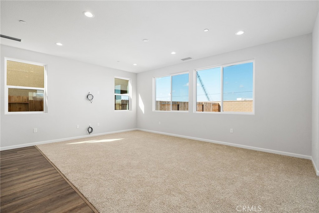 1266 Talus Way South Madera, CA 93636 - Photo 13 of 43 an empty room with wooden floor and windows