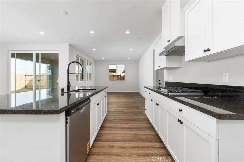 1266 Talus Way South Madera, CA 93636 - Photo 21 of 43 a large kitchen with granite countertop a stove and a sink