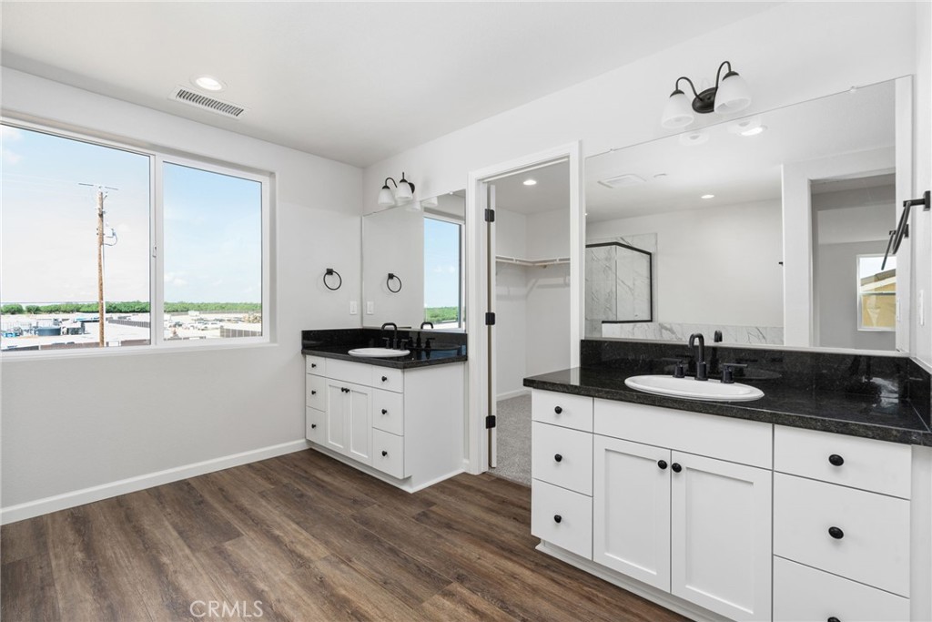 1266 Talus Way South Madera, CA 93636 - Photo 29 of 43 a kitchen with granite countertop white cabinets and white appliances