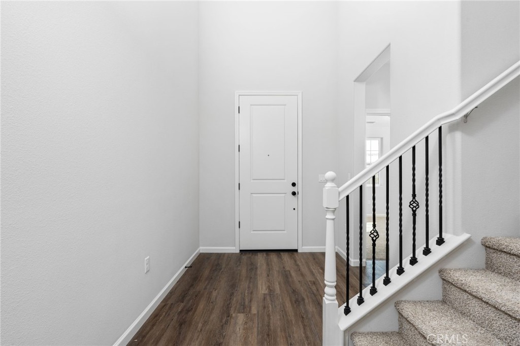 1266 Talus Way South Madera, CA 93636 - Photo 4 of 43 a view of a hallway with wooden floor and staircase