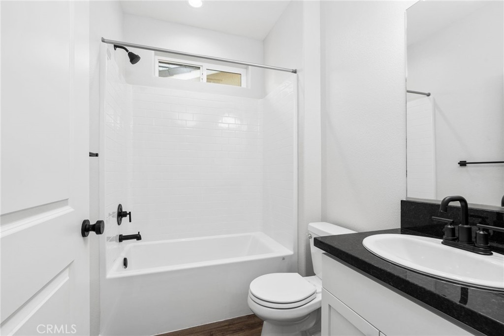 1266 Talus Way South Madera, CA 93636 - Photo 6 of 43 a bathroom with a granite countertop sink toilet a mirror and shower