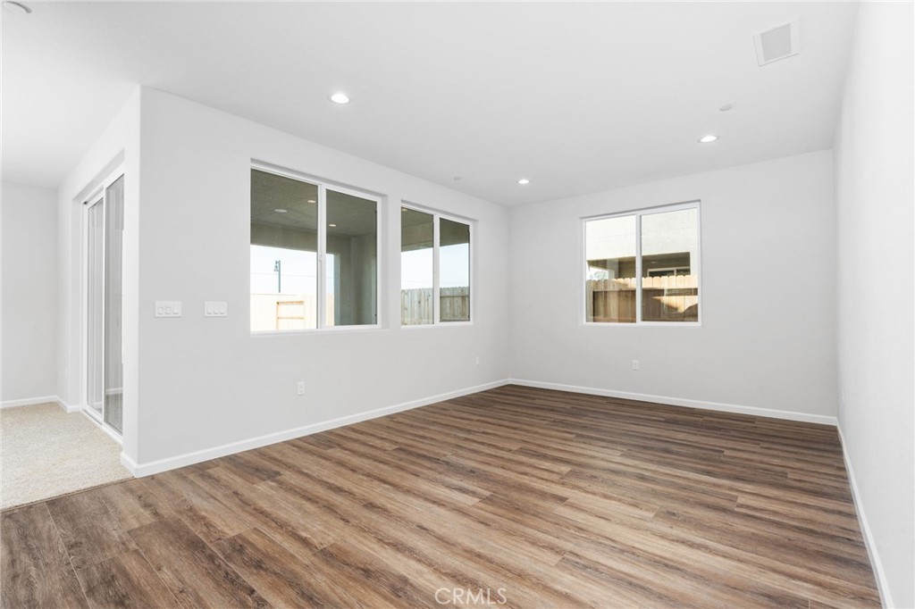 1266 Talus Way South Madera, CA 93636 - Photo 9 of 43 a view of empty room with wooden floor and fan