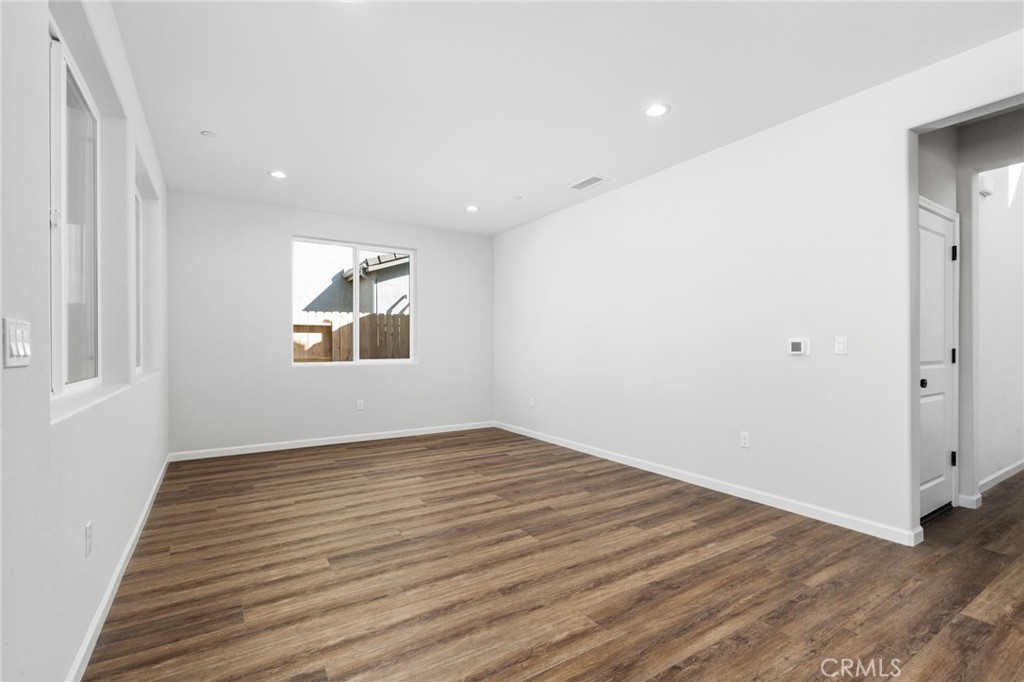 1266 Talus Way South Madera, CA 93636 - Photo 10 of 43 an empty room with wooden floor and windows