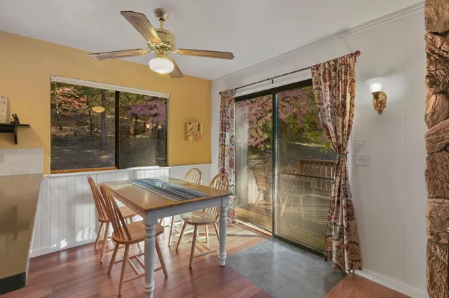 a dining room with furniture and window
