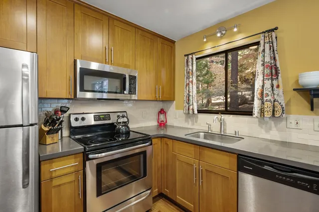 a kitchen with a sink a stove and cabinets