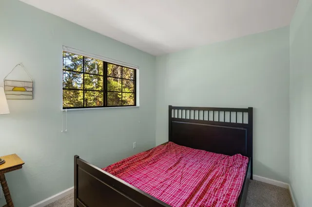 a bed room with a bed and a window