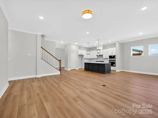 a view of kitchen and kitchen with sink wooden floor and window