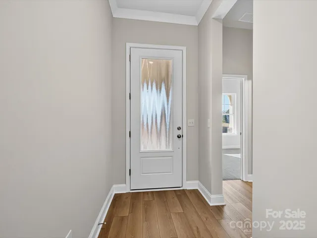 a view of front door with wooden floor